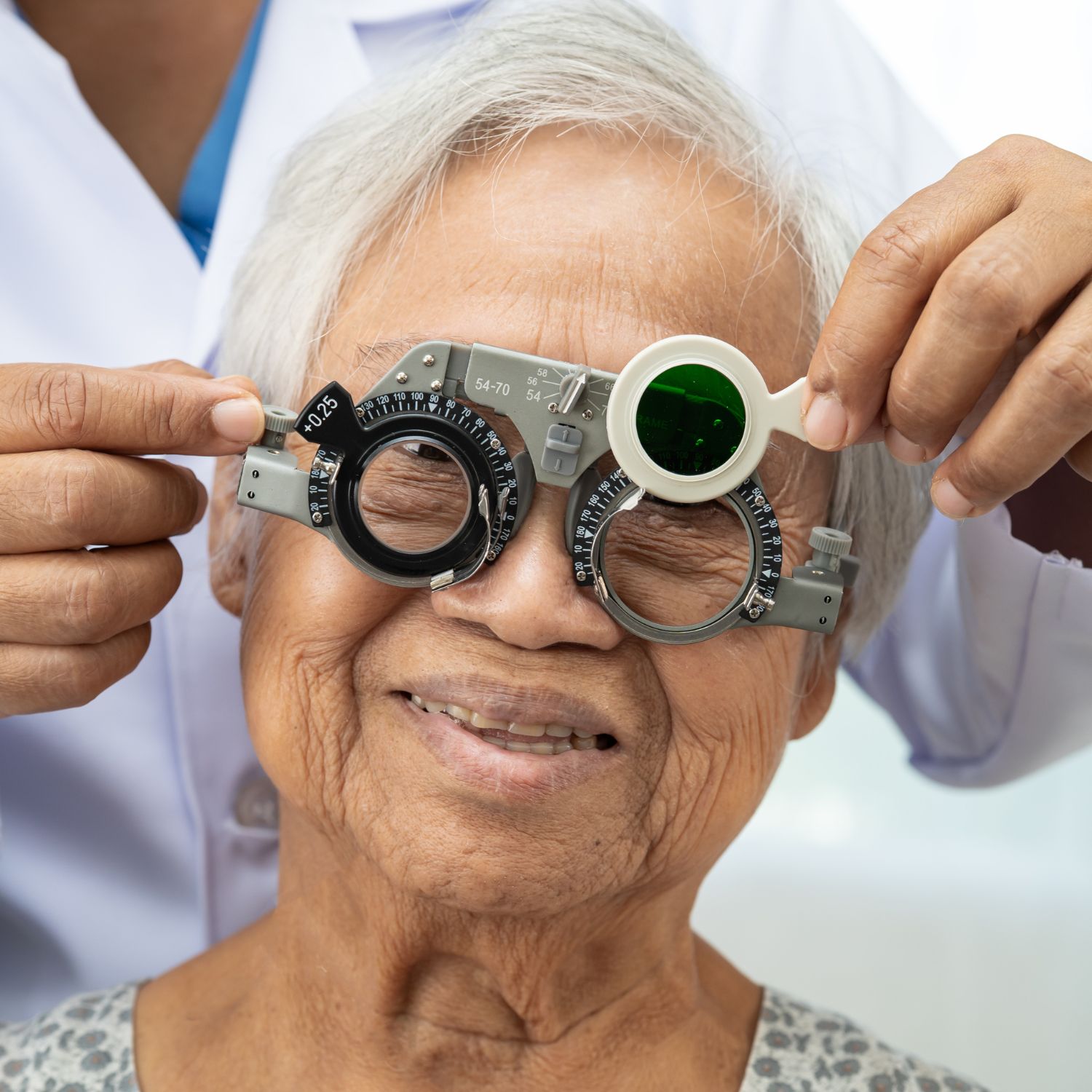 Website Graphics elderly optom macumira Elderly woman with optometric device over her eyes, being h